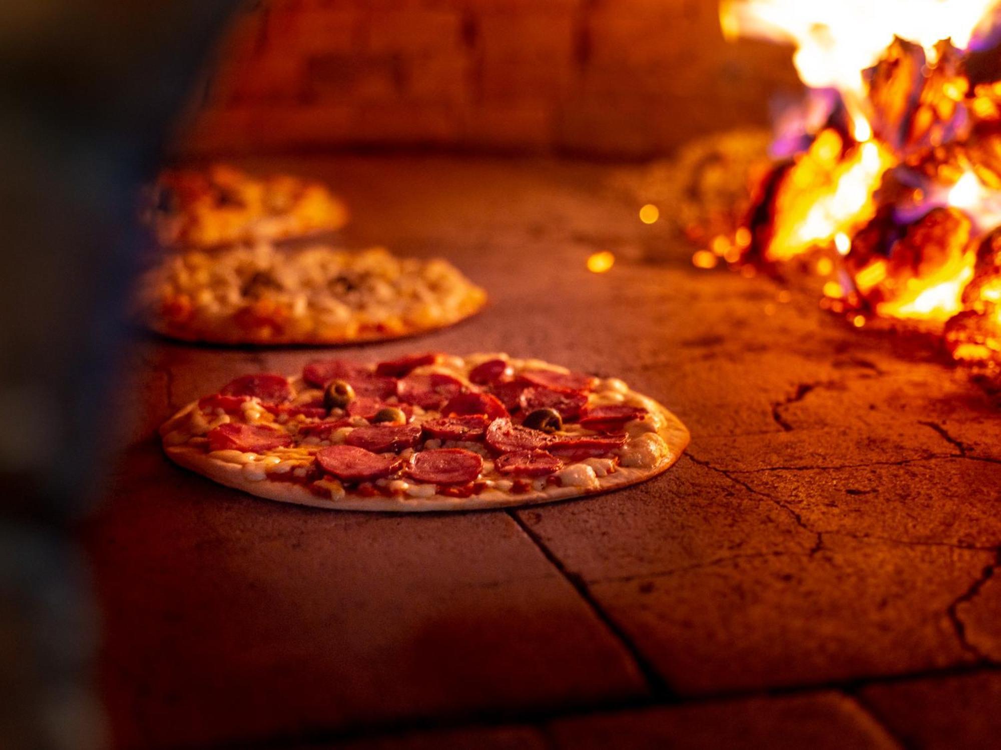 Ocean Palace All Inclusive Premium Натал Екстер'єр фото Pizza being cooked in a wood-fired oven